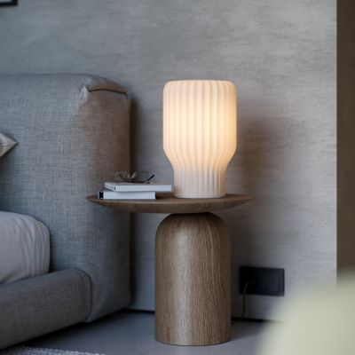 Minimalist bedside lamp emitting warm, diffuse light, inspired by Japanese paper lanterns