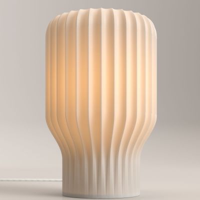 Flume table lamp by FlowForm, a 3D-printed light with wavy, fluted sides for a soft, ambient glow.